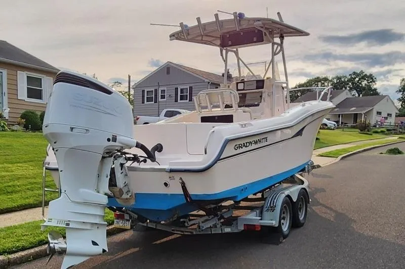 Slide: The Image of 1999 Grady-White Advance 247 boat on trailer in suburban neighborhood. - 9
