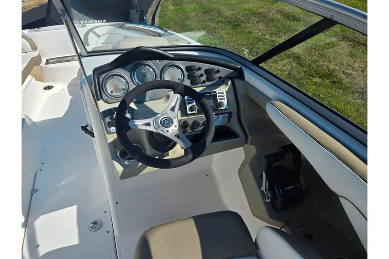 Slide: The Image of 2013 Yamaha Boats 242 Limited S dashboard with steering wheel and controls. - 13