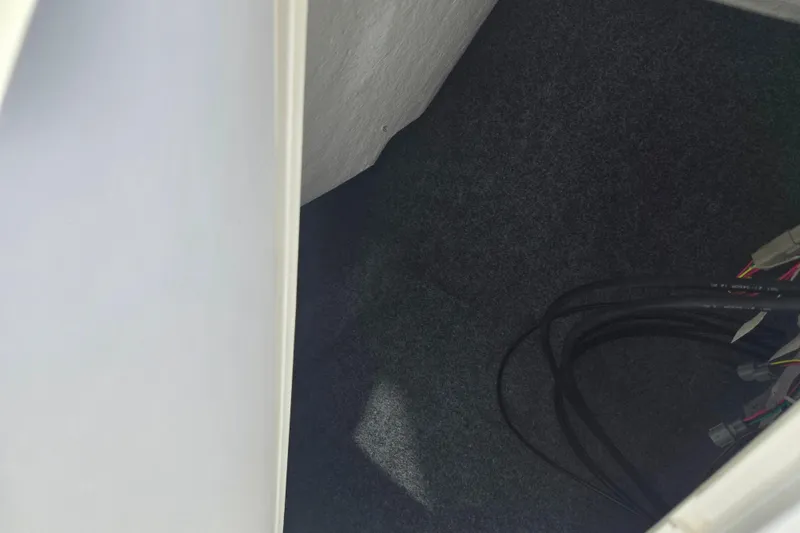 Slide: The Image of Interior view of 2013 Yamaha Boats 242 Limited S storage compartment with cables. - 16