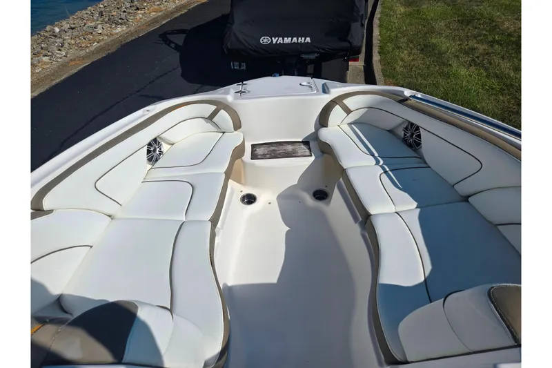 Slide: The Image of 2013 Yamaha Boats 242 Limited S interior with white seating and speakers. - 18
