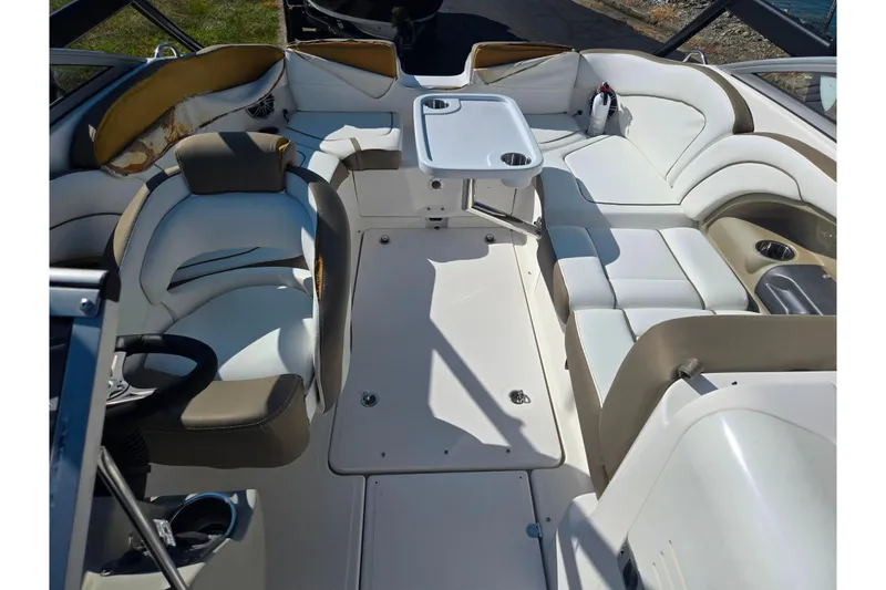 Slide: The Image of Interior of 2013 Yamaha Boats 242 Limited S, featuring spacious seating and a central table. - 23