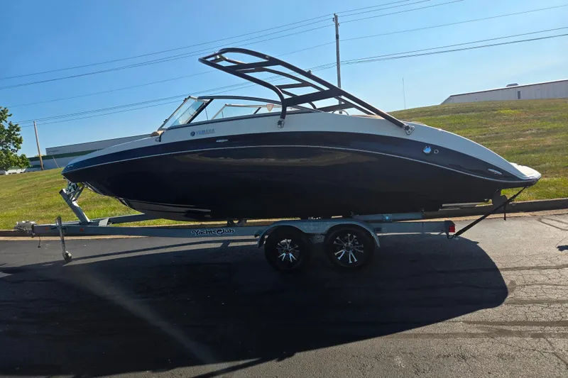 Slide: The Image of 2013 Yamaha Boats 242 Limited S on trailer, parked outdoors. - 4