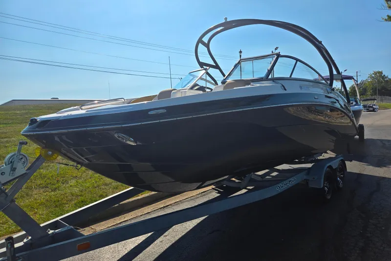 Slide: The Image of 2013 Yamaha Boats 242 Limited S on trailer, parked outdoors under clear sky. - 5