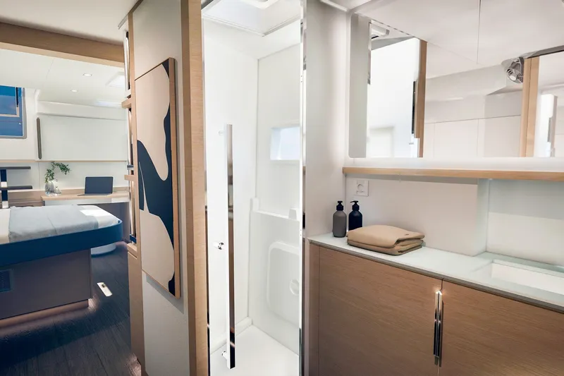 Slide: The Image of Luxurious interior of 2026 Fountaine Pajot 55 yacht, featuring modern bedroom and bathroom design. - 21