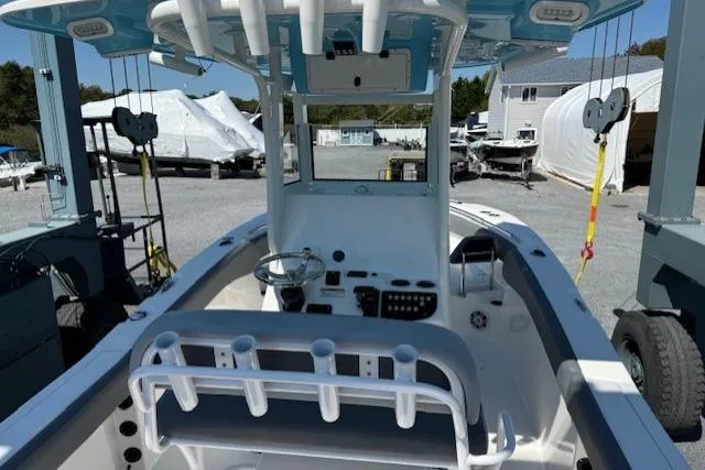 Slide: The Image of 2023 NauticStar 242L Offshore boat interior with steering console and rod holders. - 6
