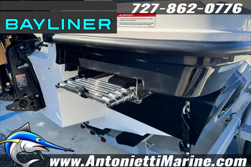 Slide: The Image of 2026 Bayliner VR4 Bowrider OB boat rear view with swim platform and ladder. - 12