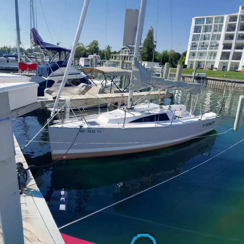 The Image of 2014 Catalina 275 Sport sailboat docked in a marina, surrounded by other boats. - 0