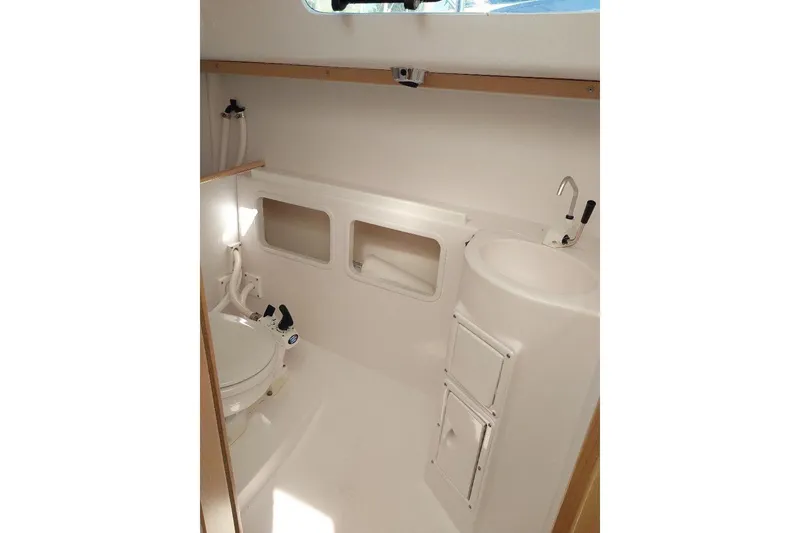 Slide: The Image of Interior of 2014 Catalina 275 Sport boat bathroom with toilet and sink. - 12
