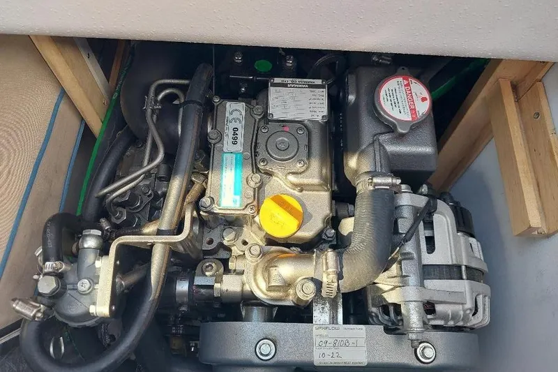 Slide: The Image of Engine compartment of a 2014 Catalina 275 Sport sailboat, showcasing mechanical components. - 13
