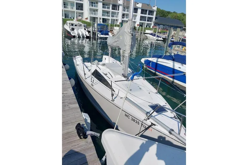 Slide: The Image of 2014 Catalina 275 Sport sailboat docked in a marina with other boats. - 3