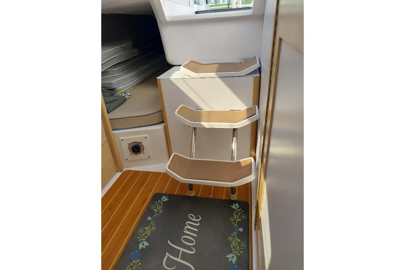 Slide: The Image of Interior of 2014 Catalina 275 Sport sailboat with wooden flooring and compact steps. - 8