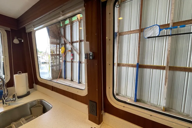 Slide: The Image of Interior view of 2021 American Tug 362, featuring kitchen sink and large windows. - 10