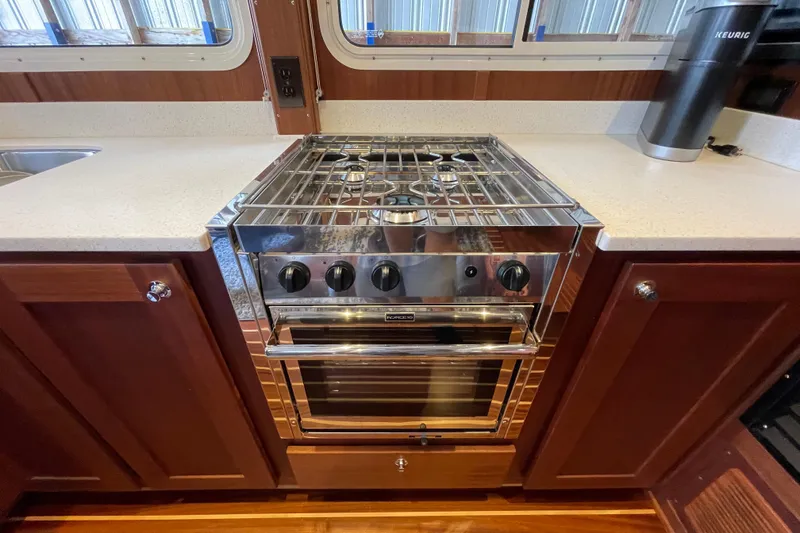 Slide: The Image of Modern kitchen stove in 2021 American Tug 362 boat interior. - 11