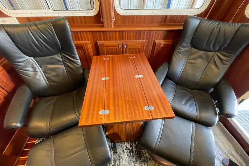 Slide: The Image of Luxurious interior of 2021 American Tug 362 with leather chairs and wooden table. - 16