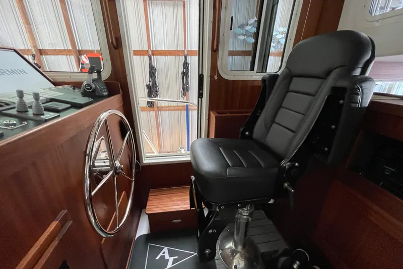 Slide: The Image of Interior helm of 2021 American Tug 362 with steering wheel and captain's chair. - 22