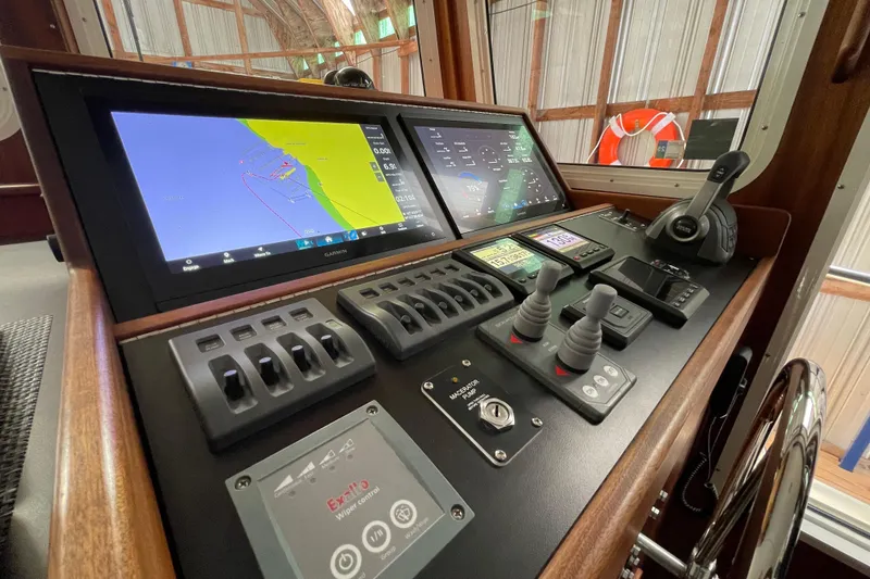 Slide: The Image of Control panel of 2021 American Tug 362 with navigation screens and controls. - 24