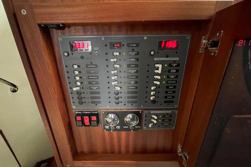 Slide: The Image of Electrical control panel on a 2021 American Tug 362 boat, featuring switches and digital displays. - 29