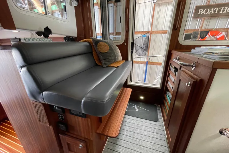 Slide: The Image of Interior of 2021 American Tug 362 with gray seating and wooden cabinetry. - 31