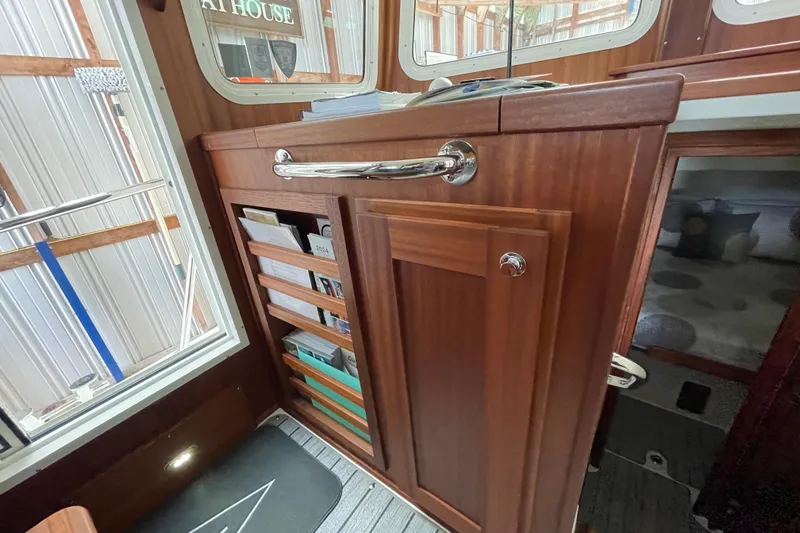 Slide: The Image of Interior of 2021 American Tug 362 with wooden cabinetry and storage shelves. - 33