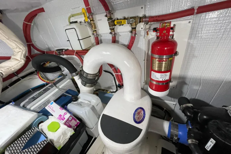 Slide: The Image of Engine room of 2021 American Tug 362 with fire extinguisher and mechanical components. - 36