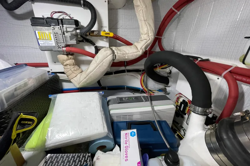 Slide: The Image of Engine room of 2021 American Tug 362 with various equipment and wiring. - 37