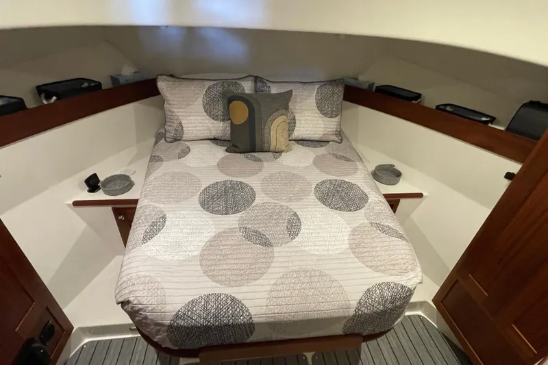 Slide: The Image of Cozy cabin interior of 2021 American Tug 362 with patterned bedding and wooden accents. - 39
