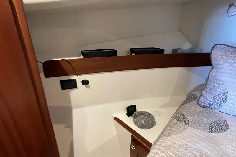 Slide: The Image of Cozy cabin interior of 2021 American Tug 362 with bed and wooden accents. - 42