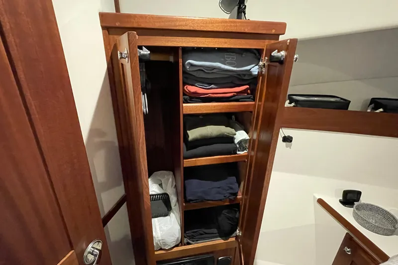Slide: The Image of Wooden closet with neatly folded clothes inside American Tug 362, 2021 model. - 43