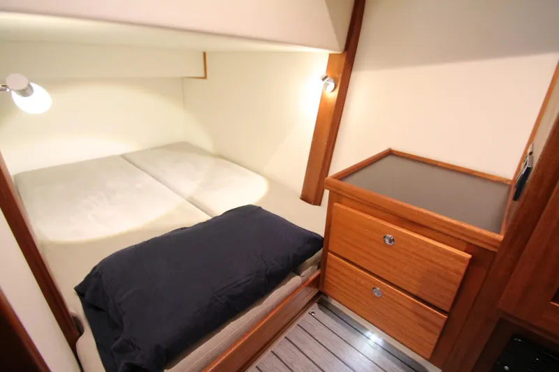 Slide: The Image of Cozy cabin interior of 2021 American Tug 362 with bed and wooden storage drawers. - 45