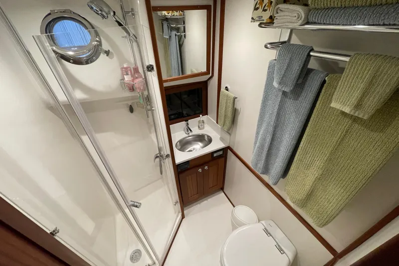 Slide: The Image of Bathroom interior of 2021 American Tug 362 with shower, sink, and towels. - 46