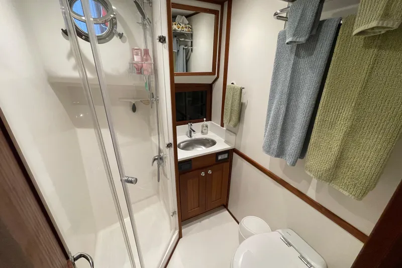Slide: The Image of Bathroom interior of 2021 American Tug 362 with shower, sink, and towels. - 47