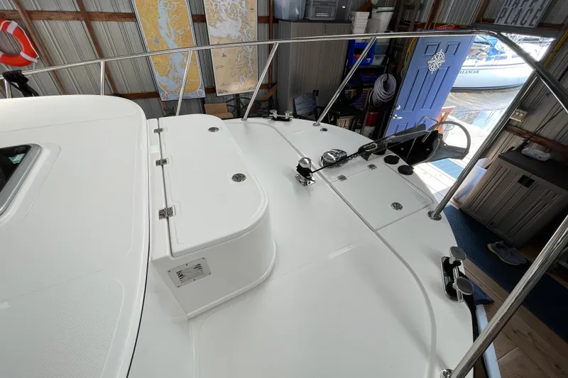 Slide: The Image of 2021 American Tug 362 boat deck with railing, docked in a marina shed. - 48