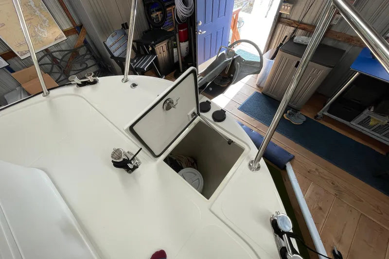 Slide: The Image of American Tug 362 (2021) deck with open storage hatch in a workshop setting. - 52