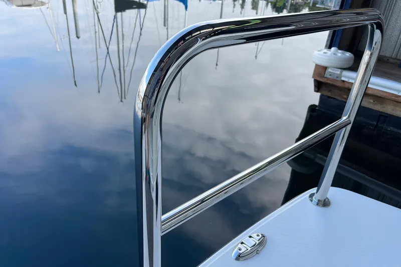 Slide: The Image of Chrome railing on 2021 American Tug 362 boat, reflecting sky and water. - 61