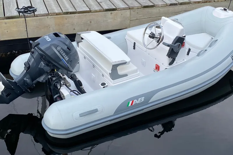 Slide: The Image of A 2021 American Tug 362 with Yamaha outboard motor docked by wooden pier. - 64