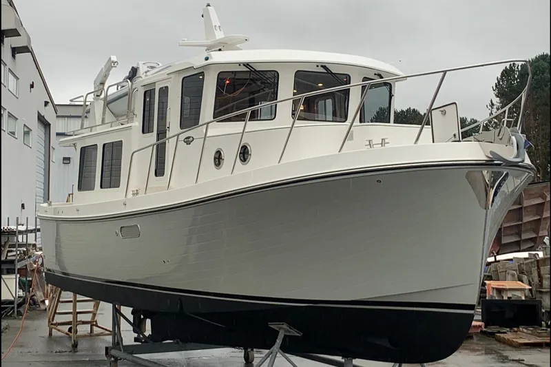 Slide: The Image of 2021 American Tug 362 boat on dry dock, showcasing sleek design and sturdy construction. - 7