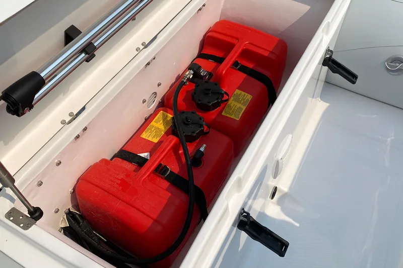 Slide: The Image of Storage compartment with red fuel tanks on a 2021 American Tug 362 boat. - 70