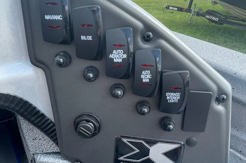 Slide: The Image of Control panel of 2026 Xpress H20 Bass boat with labeled switches and buttons. - 10
