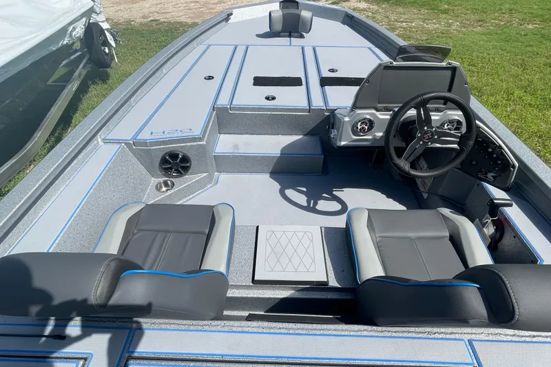Slide: The Image of 2026 Xpress H20 Bass boat interior with modern seating and steering console. - 3