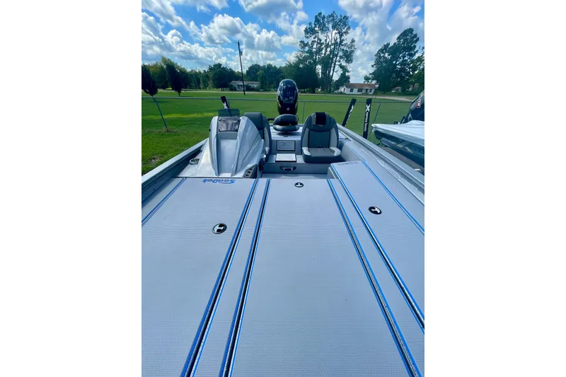 Slide: The Image of 2026 Xpress H20 Bass boat with sleek deck design under a blue sky. - 4