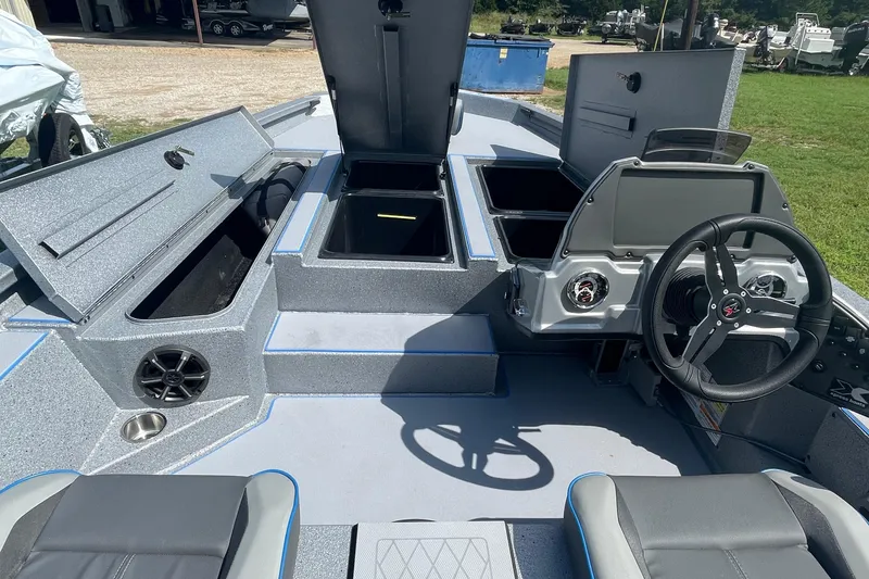 Slide: The Image of 2026 Xpress H20 Bass boat interior with open storage compartments and steering console. - 6