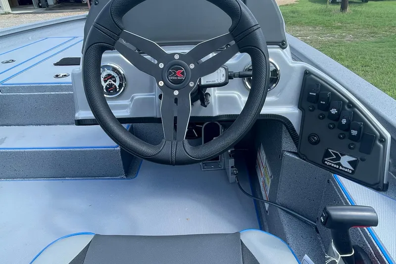 Slide: The Image of 2026 Xpress H20 Bass boat cockpit with steering wheel and control panel. - 9