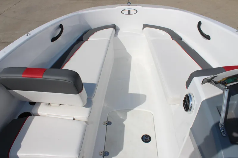 Slide: The Image of 2023 Tahoe T16 boat interior with white and gray seating, red accents, and storage compartments. - 11