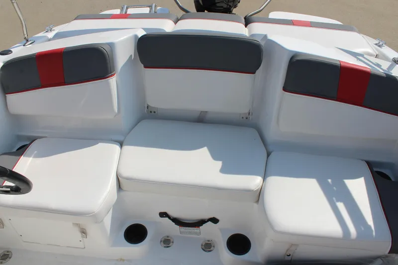 Slide: The Image of 2023 Tahoe T16 boat interior with white and gray seating, red accents. - 13