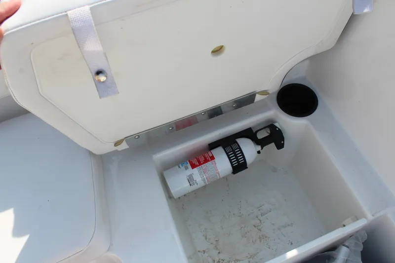 Slide: The Image of 2023 Tahoe T16 storage compartment with fire extinguisher and cup holder. - 15