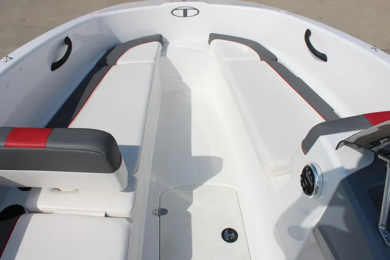 Slide: The Image of 2023 Tahoe T16 boat interior with white and gray seating, red accents, and modern design. - 16