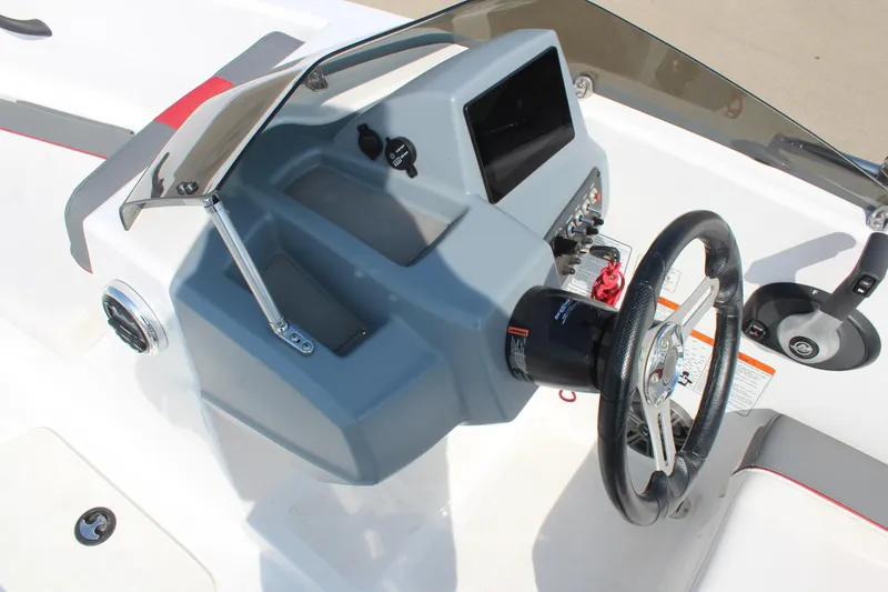 Slide: The Image of 2023 Tahoe T16 boat dashboard with steering wheel and control panel. - 17