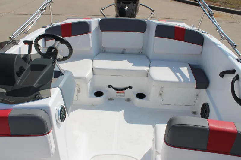 Slide: The Image of 2023 Tahoe T16 boat interior with seating and steering wheel, featuring red and gray accents. - 18