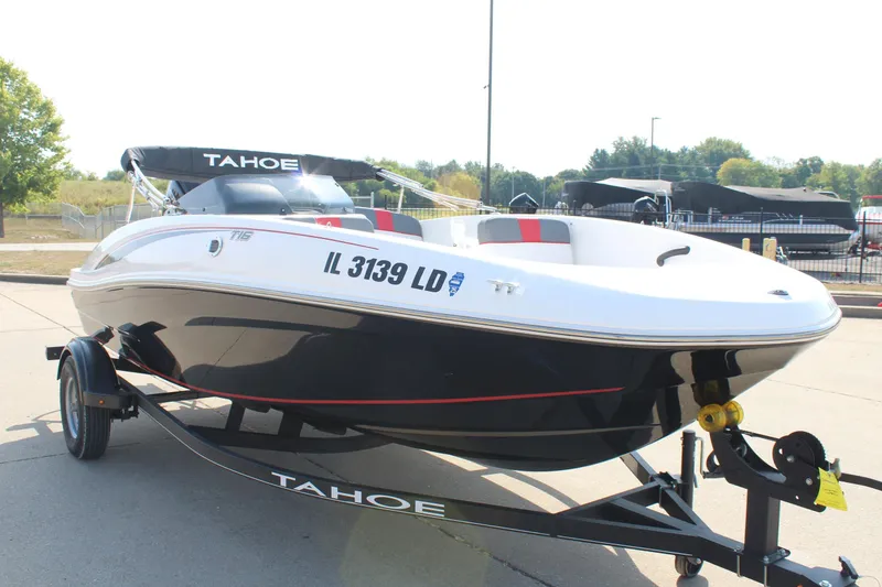 Slide: The Image of 2023 Tahoe T16 boat on trailer, black and white design, parked outdoors. - 3