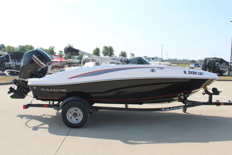 Slide: The Image of 2023 Tahoe T16 boat on trailer with Mercury outboard motor, parked outdoors. - 4